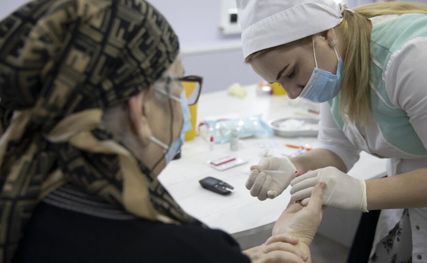 A woman undergoes antibody testing before an injection of the Russian COVID-19 vaccine known as Sputnik V at an outpatient clinic in Grozny earlier this week.