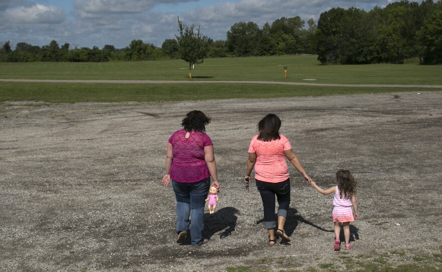 Beth Carey (center), walks around the park with her nieces Calysta Dildine, 15, and Jazlen Harden, 3, in Marion. Chrystina, Beth's twin sister and Jazlen and Calysta's mother, died of a drug overdose in February of 2013.