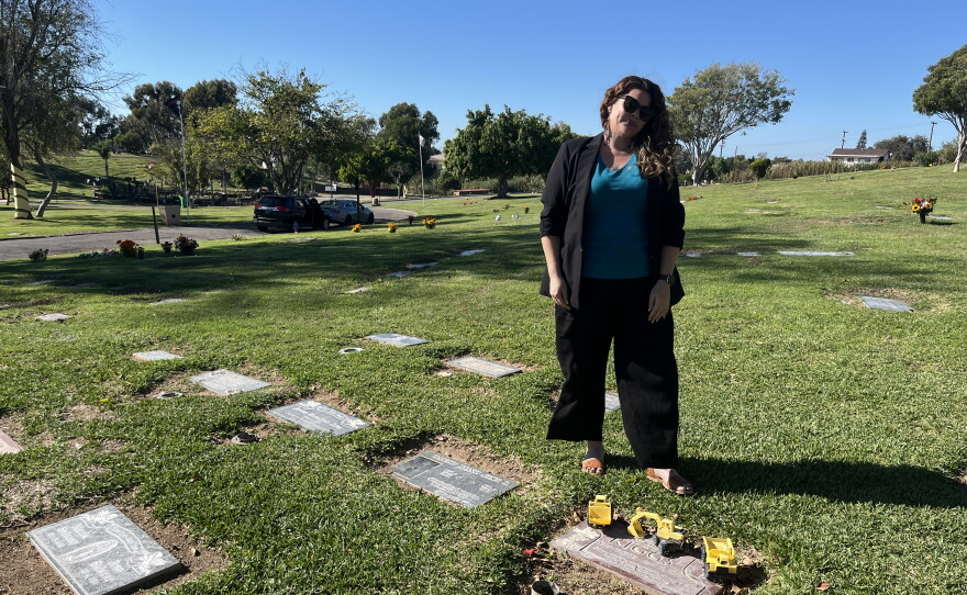 Angela Riggs stands above her son's resting place at La Vista Memorial Park, Oct. 26, 2026.