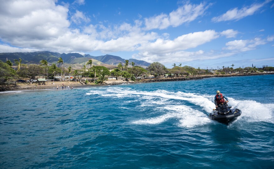 The local surfing community are shuttling donated items on jet boats from large boats to the shore in Lahaina.