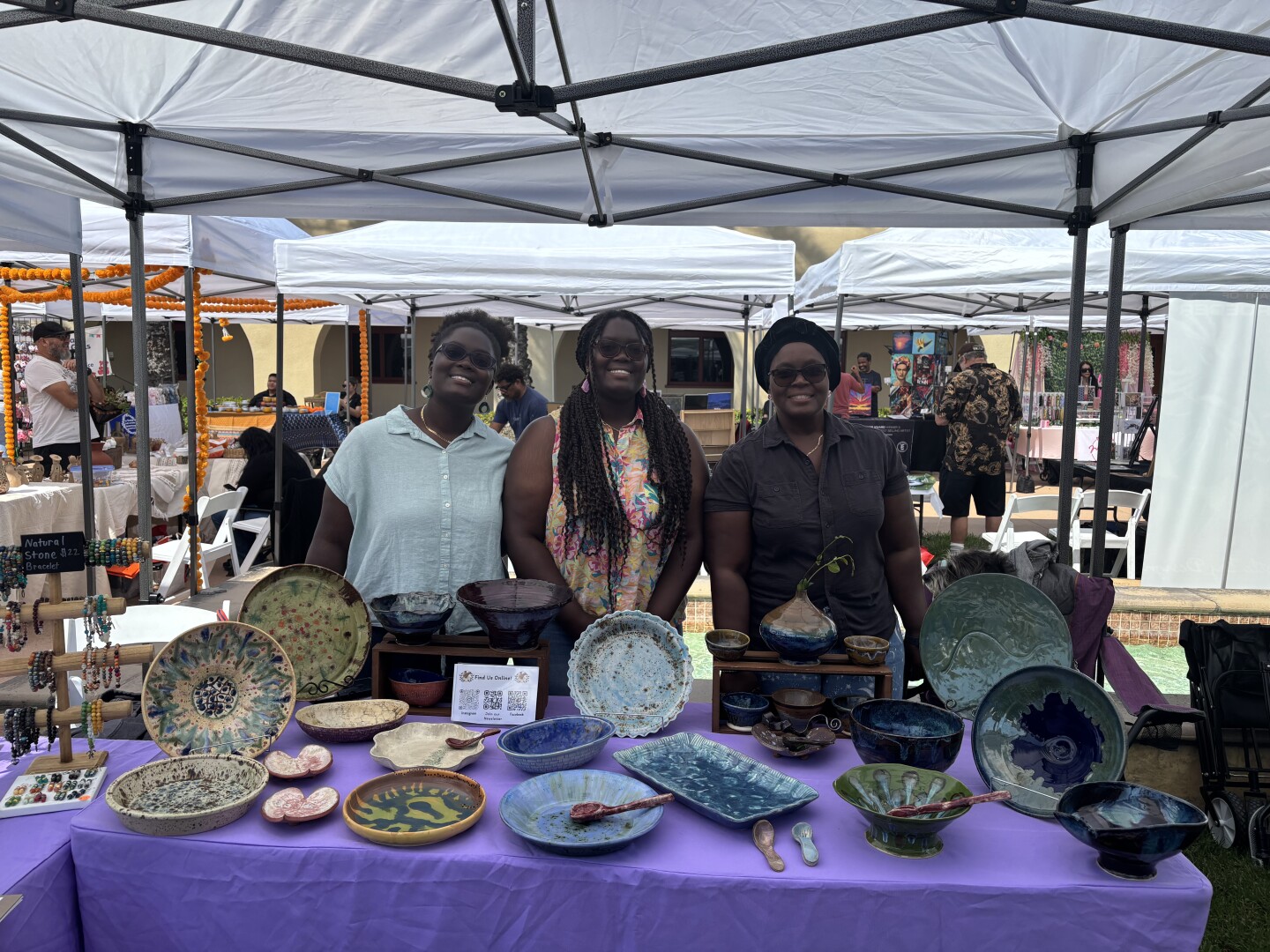 Patricia A. (left) and Priscilla A. Coelho (middle) and their mother Kouassi A. Romero(right) in front of Kouassi's pottery outside of Chula Vista City Hall on Sept. 27, 2025