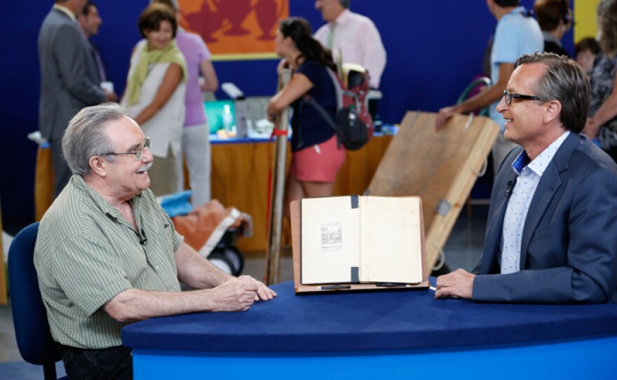 Timothy Gordon (right) appraises a 1963 Jim Morrison inscribed book for $8,000 to $10,000 in Baton Rouge, La.