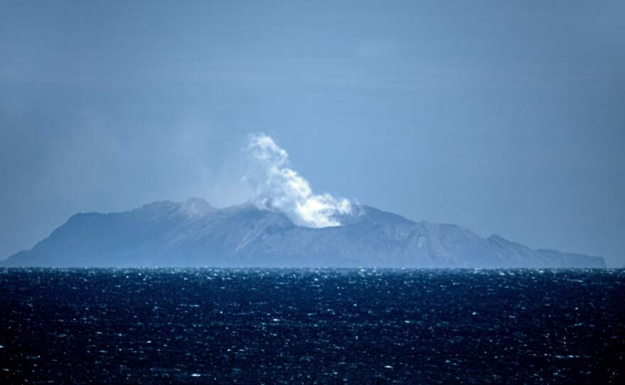 Steam rises from the volcano on New Zealand's White Island on Tuesday, one day after an eruption there left at least six people dead, more than 30 injured and still others missing. Questions linger about why so many people were allowed so close to the active volcano.