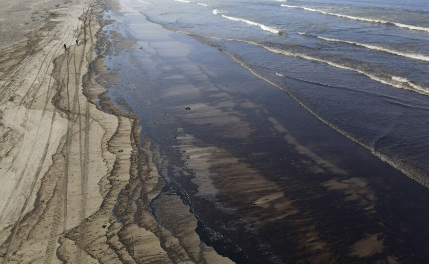 Oil pollutes Cavero beach in Ventanilla, Callao, Peru, on Tuesday after high waves attributed to the eruption of an undersea volcano in Tonga caused an oil spill.