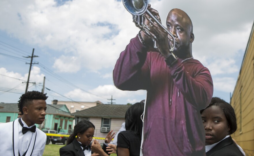 Family and friends carry a life-size cutout of New Orleans musician, Travis "Trumpet Black" Hill, during the jazz funeral for the 28-year-old. Hill died of an infection on May 4, 2015, while on tour in Japan.