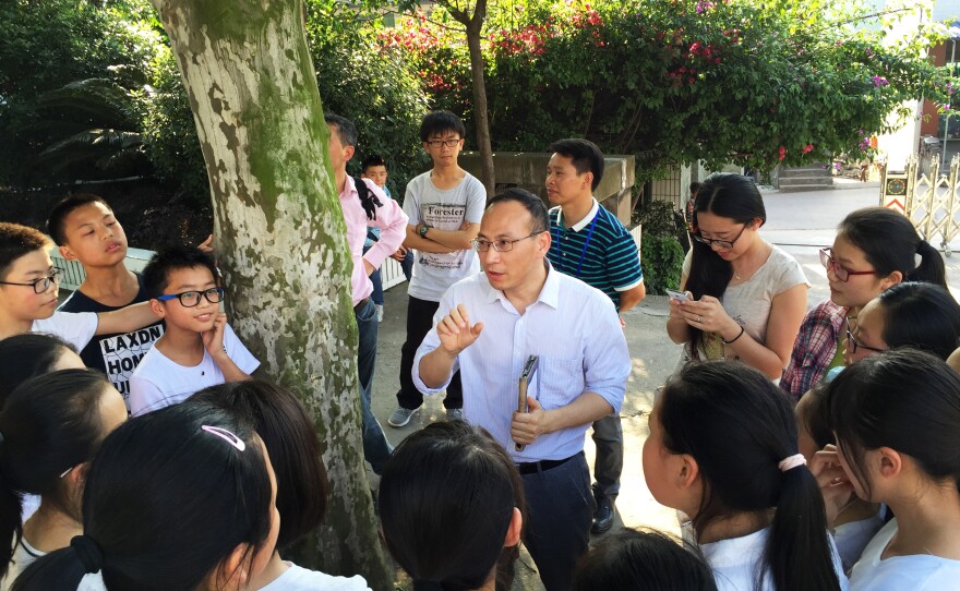 Zhang Liang, a reformist educator and social entrepreneur, talks to students after class at Cold Water Well Middle School. Zhang advocates breaking down the traditional course structure, and restructuring education around the needs of the students.