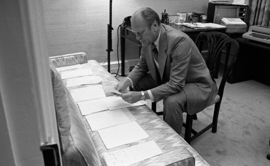 President Ford examines documents related to potential vice presidential nominees on August 15, 1974.