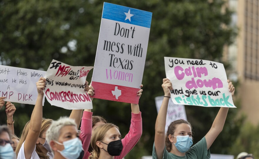 People take part in the Women's March ATX rally, Oct. 2, at the Texas State Capitol in Austin. The march was a response to a Texas law that bans most abortions.