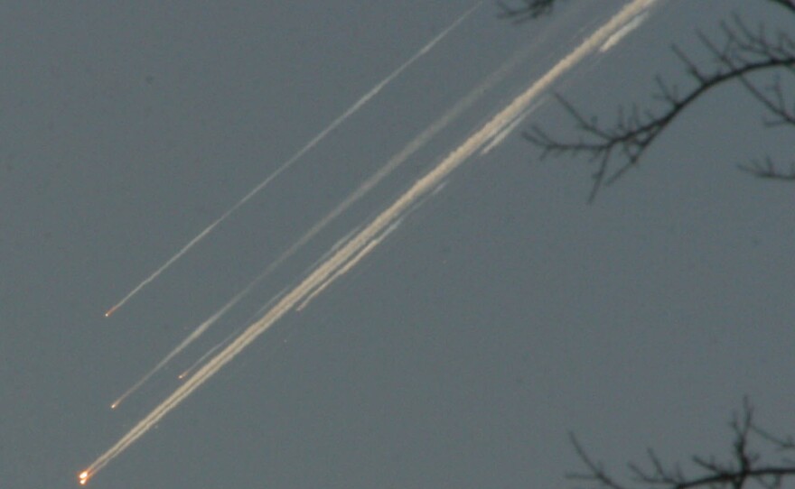 Debris from the space shuttle Columbia streaks across the Texas sky as seen from Dallas on Feb. 1, 2003.