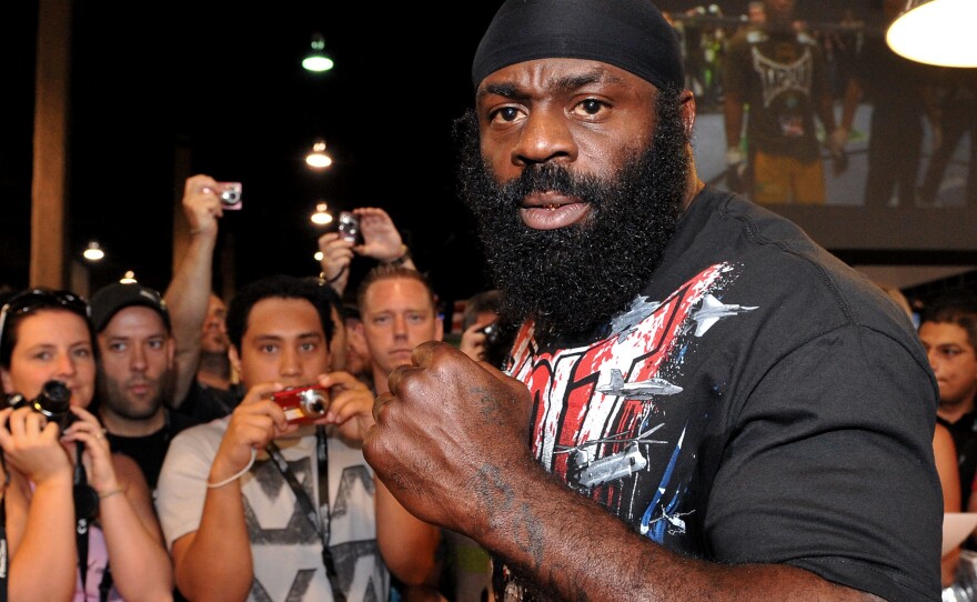 Kimbo Slice signs autographs at the UFC 100 Expo in Las Vegas in 2009. Slice died suddenly Monday at the age of 42.