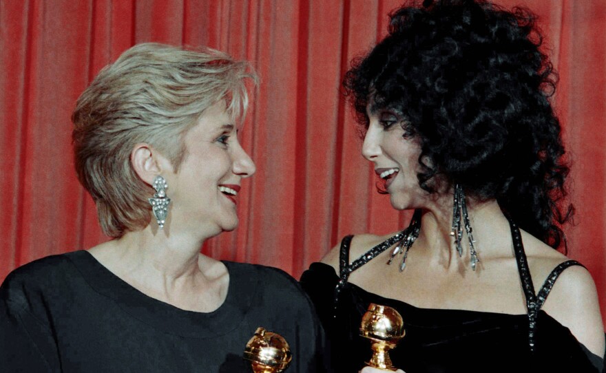 In this Jan. 24, 1988 photo, actress Olympia Dukakis and Cher hold the Golden Globe awards they received for performances in the hit movie Moonstruck at the Beverly Hilton Hotel.