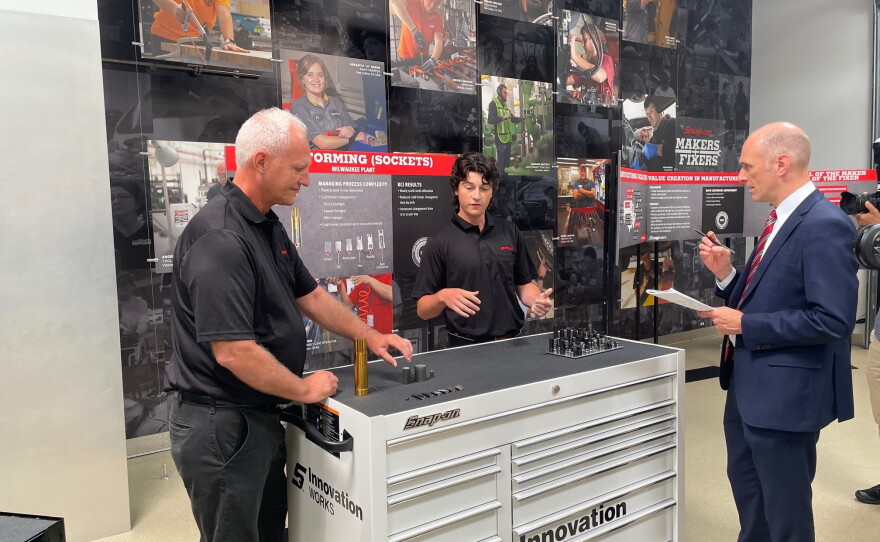 (left to right) Snap-on employees Dave Wachsmuth and Matt Buckley explain the socket-making process to Chicago Federal Reserve Bank president Austan Goolsbee. Snap-on makes 85,000 different tools, including 74 varieties of 10 mm sockets.
