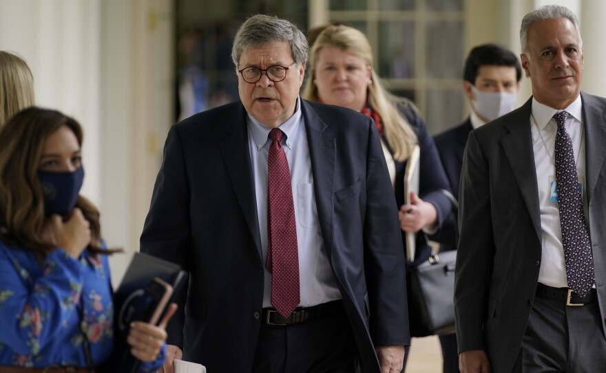 Attorney General William Barr, center, arrives for an event on police reform last month at the White House. Barr is expected to face tough questioning when he appears Tuesday before the House Judiciary Committee.