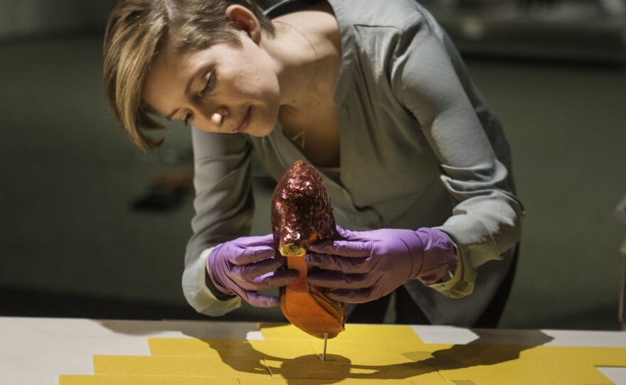 The slippers are delicate and made of multiple materials; curators say research is needed to determine the best way to store them.