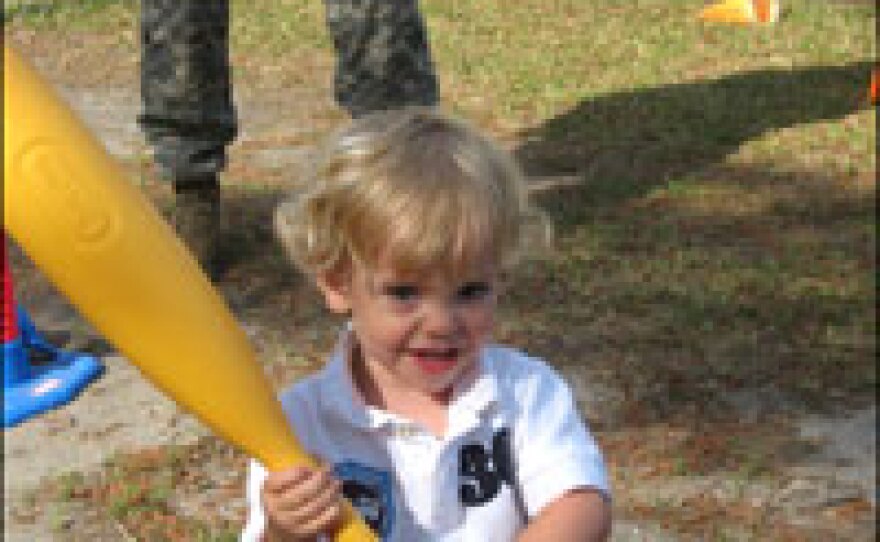 Drew DeUnger celebrates after hitting the ball as his father teaches him the fundamentals of softball. Andy DeUnger spends as much time as possible with his son before he deploys.