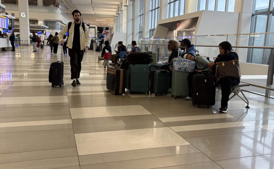 Travelers pass the time at LaGuardia on Monday morning.