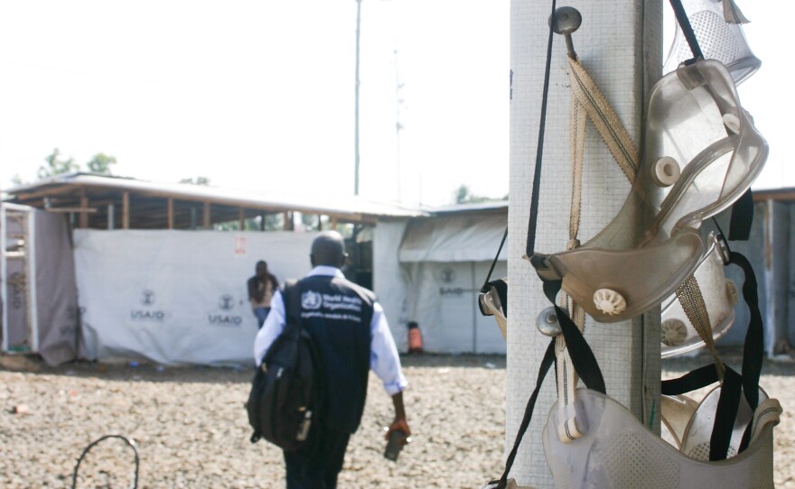 Dr. Michael Mawanda, from the World Health Organization, walks past goggles left to dry during the last days of operation at the Ministry of Defense ETU.