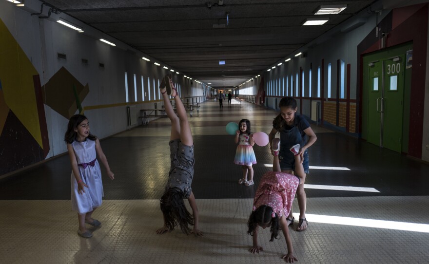Syrian refugee girls (from left) Shahd Alamar, 8, Lana Alkhawaja, 9, Maya Alamar, 4, Amal Sakkal, 8, and Hala Alhalaby, 8, play in a hallway at the former prison of Bijlmerbajes in Amsterdam.