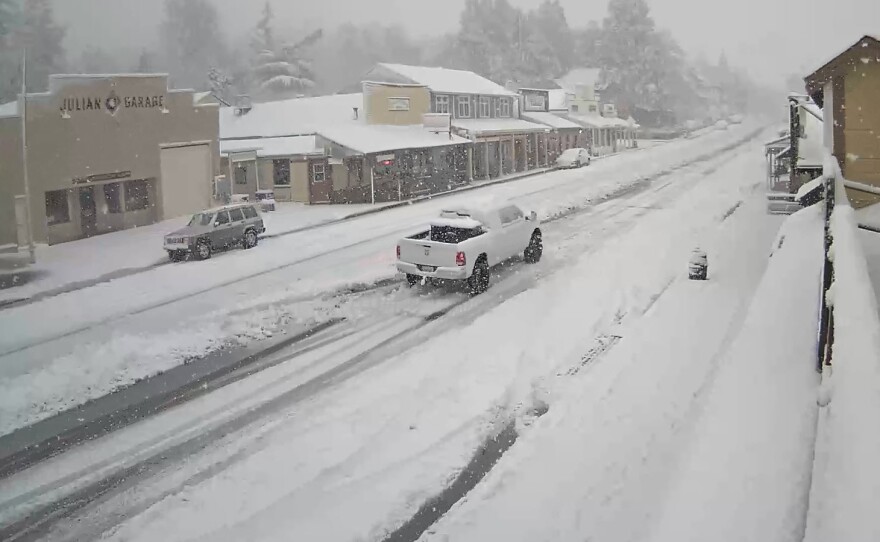 A truck drives through snowy streets in Julian, Calif. Feb. 7, 2024.
