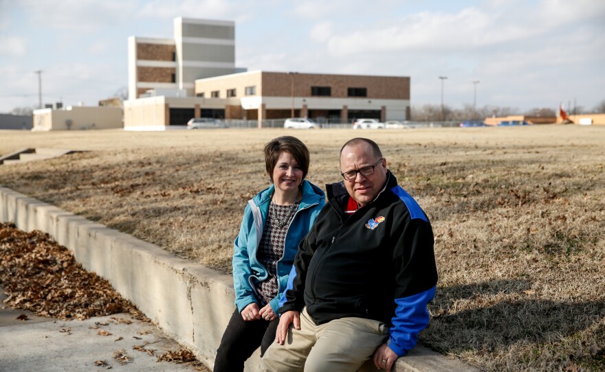 Andy Taylor and his wife, Amy, sit near the town's hospital, which was shut down in 2015.