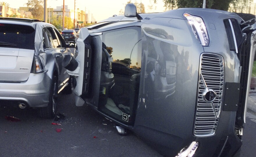 This March 24 photo provided by the Tempe, Ariz., Police Department shows an Uber self-driving SUV that flipped onto its side in a collision.