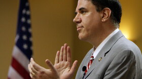 Rep. Alan Grayson (D-FL) leads a round of applause for physicians who attended a town hall meeting on health care Monday in Tavares, Fla.