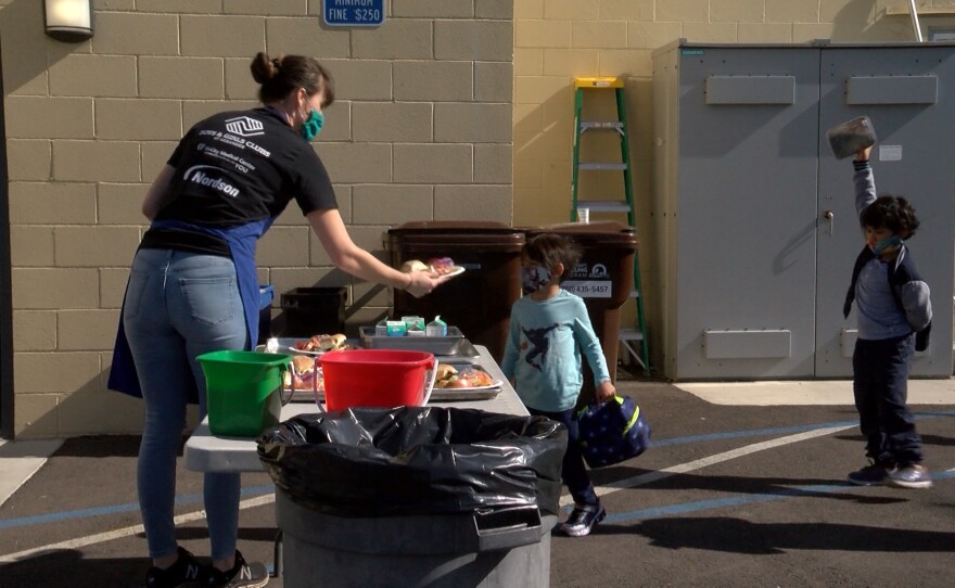 Children receiving lunch from staff at the Boys and Girls Club in Oceanside. November 18, 2020.