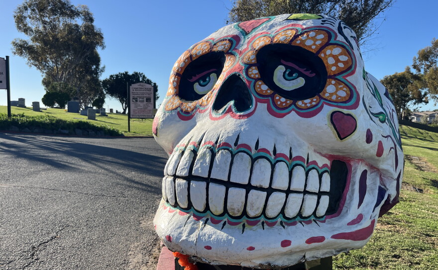 A large, hand-crafted calavera, or skull, sits on a raised platform at La Vista Memorial Park, Oct. 26, 2026.