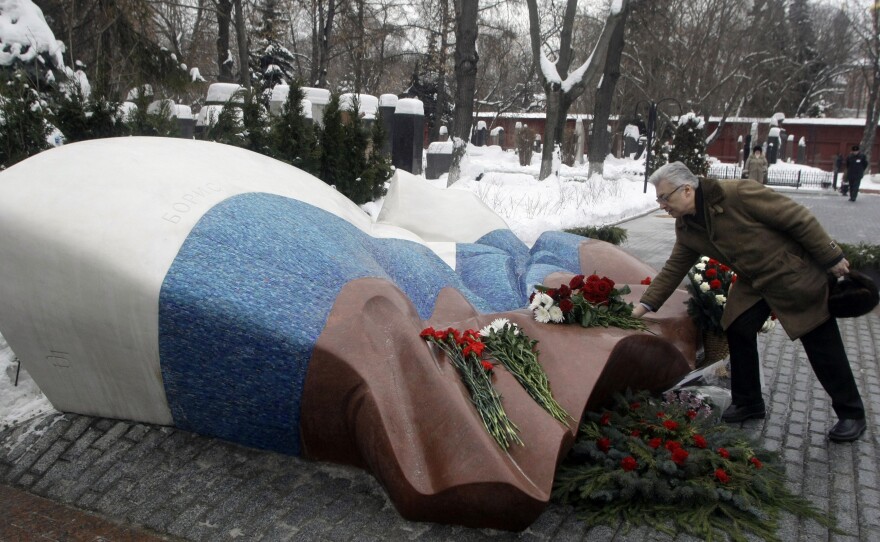 Former aide Yuri Baturin lays flowers at the grave of Russian President Boris Yeltsin at the Novodevichy cemetery in Moscow.