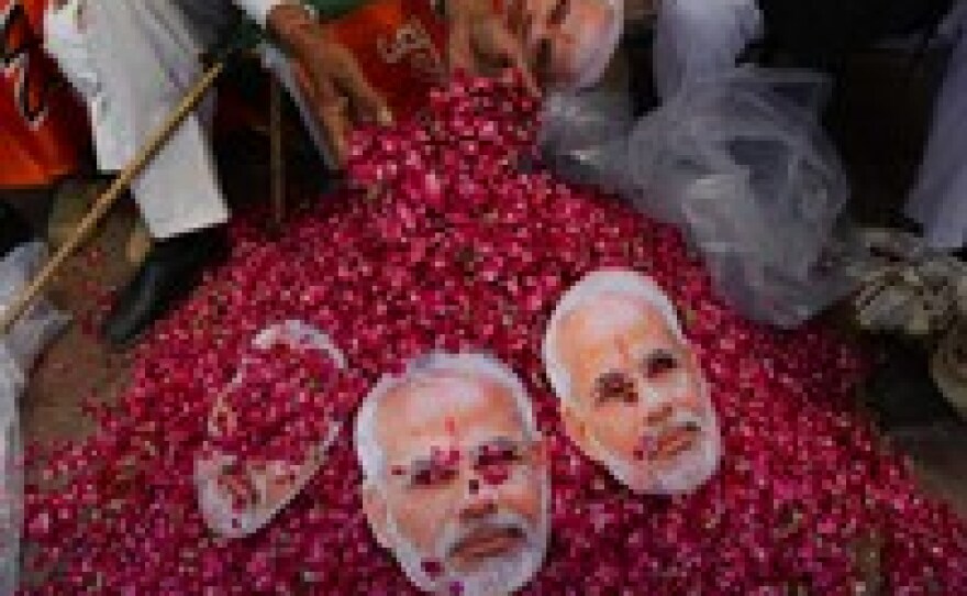 An Indian supporter of Modi collects flowers on Saturday.