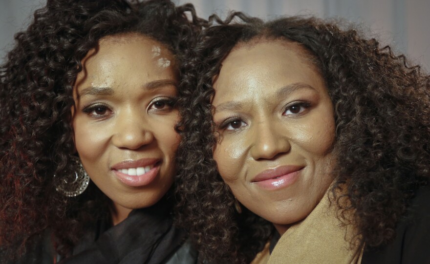 In this Wednesday, Feb. 6, 2013 photo, Swati Dlamini-Mandela, left, and Zaziwe Mandela-Manaway, granddaughters of Nelson and Winnie Mandela, pose during an interview in New York.