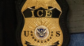 FILE - A federal agent wears an Immigration and Customs Enforcement badge, June 10, 2025, in New York.