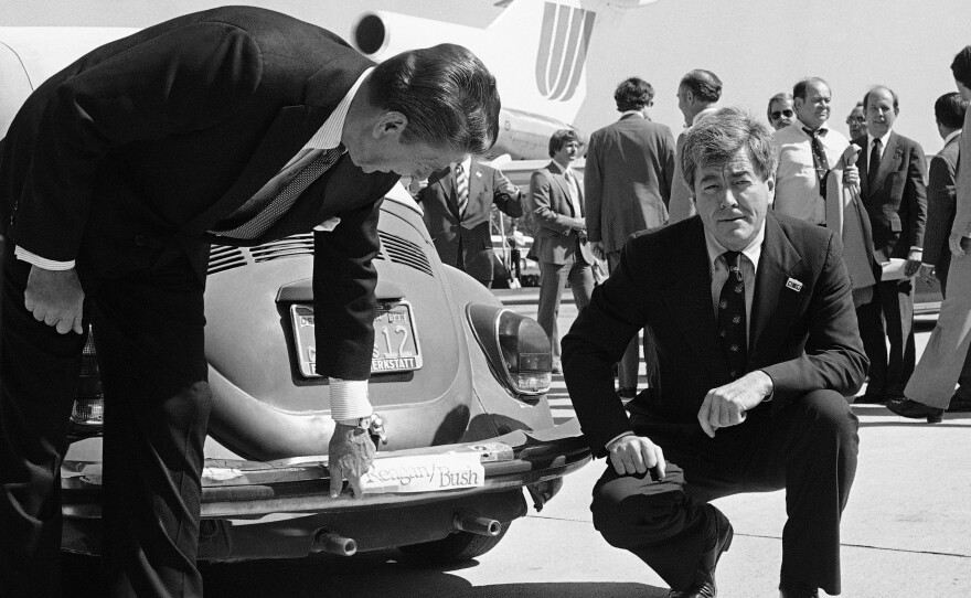 Republican presidential candidate Ronald Reagan admires the bumper sticker on the car of Rep. Pete McCloskey as the congressman looks on, right, in San Jose, Calif., Sept. 25, 1980.