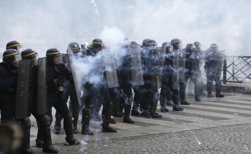 Riot police officers take position as they face demonstrators during the May Day demonstration in Paris. Paris police reportedly fired tear gas at rowdy protesters on the sidelines of the May Day workers march.