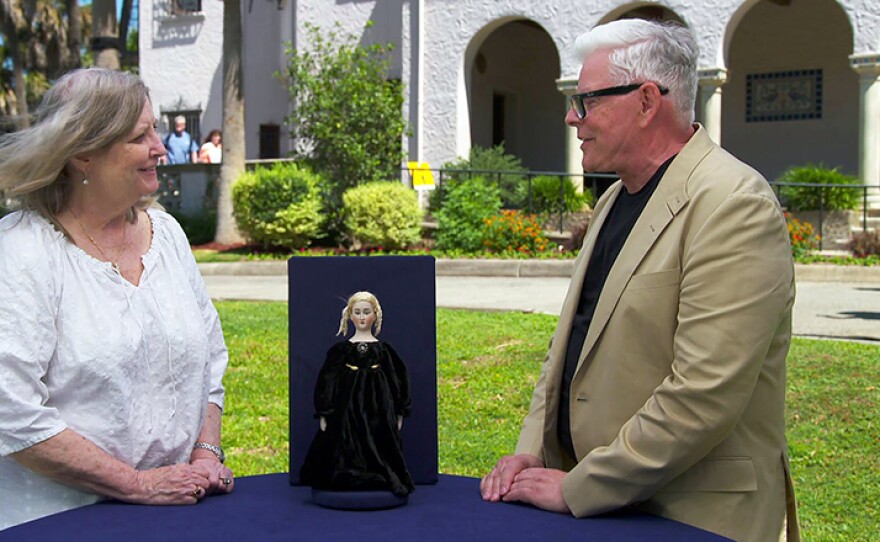 Marshall Martin (right) appraises a Simon & Halbig adult-face doll, ca. 1910, at McNay Art Museum in San Antonio, Texas.