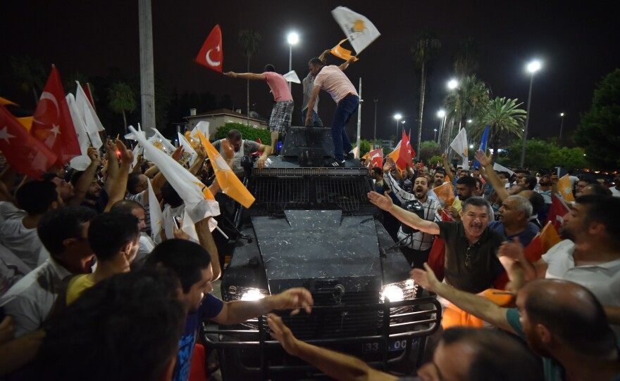 People react against the military coup attempt in Mersin early Saturday.