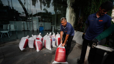 Workers place sandbags outside a restaurant as Hurricane Simon approaches Puerto Vallarta, Mexico, Saturday, Oct. 10, 2026.