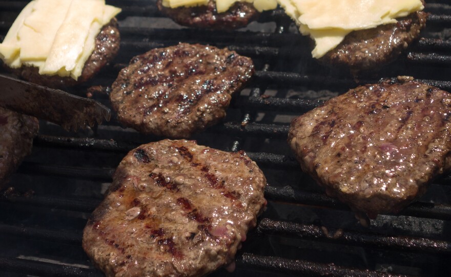 Advocates for healthy food in Virginia schools have met a reversal, after cafeterias changed back to hamburgers with additives due to students' complaints. Here, burgers are grilled at a farmer's market this summer.