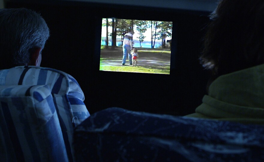Filmmaker Angelo Madsen Minax's parents watch a home video.
