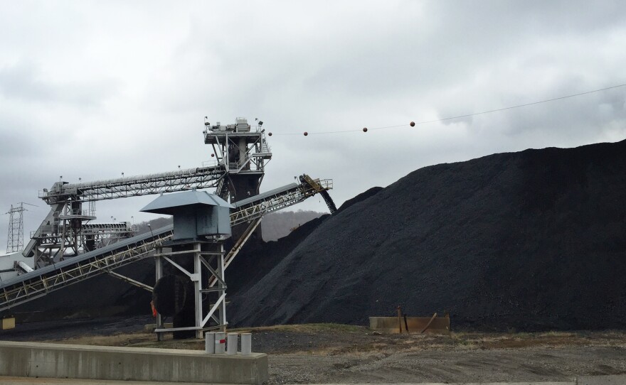 Coal from neighboring mines arrives at the Powhatan Transportation Center by train and truck. The coal from this stockpile goes onto a conveyor belt and drops down a chute before being loaded onto a barge for distribution across the Ohio River.