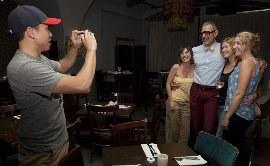 Fans take their picture with Goldblum before the show at Rockwell club in Los Angeles. Goldblum likes to mingle with audience members before the show. "Nobody works the room like Jeff Goldblum," says John Mastro, the band's manager.