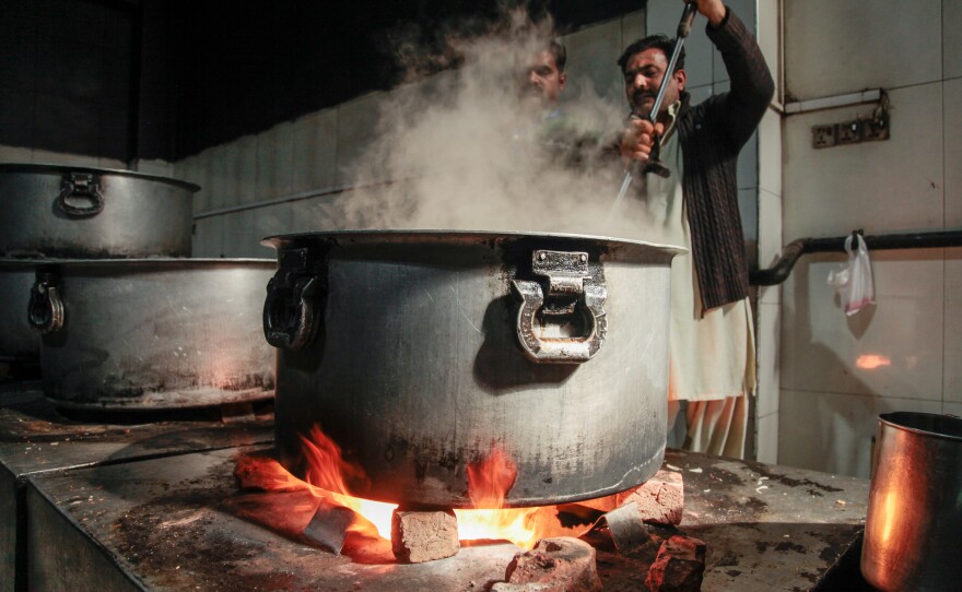 Steaming cauldrons of free food are a growing sight in Pakistan, where economic hardships have made it difficult for many to afford food. Above: A cook stirs a pot in the industrial kitchen on the ground floor of the Pakistani charity Saylani. A branch of the charity in the city of Faisalabad provides lunch to some 20,000 people each day.