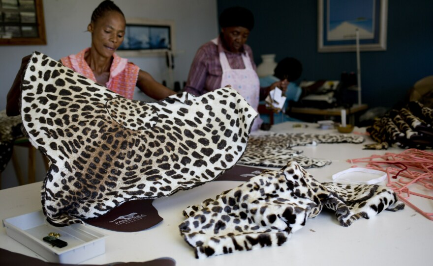 Workers make fake leopard skin clothes in Durban, South Africa, in 2014. Leopard skins symbolize pride and royalty in the Shembe Church, a traditionalist Zulu church. But as lost habitat and poaching have sent the cats' numbers plummeting, church leaders have agreed with conservationists to offer a cheaper, synthetic alternative.
