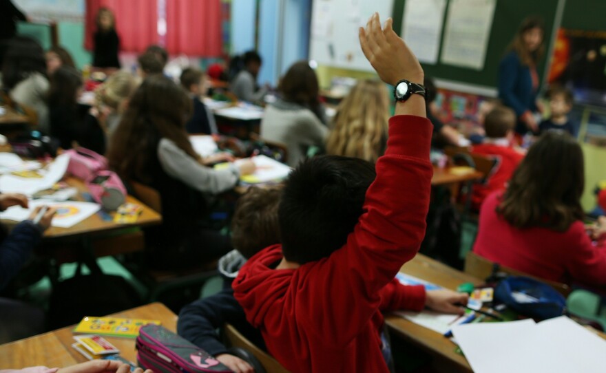 Children attend a lesson in a classroom of a primary school, in Cherbourg-Octeville, northwestern France.