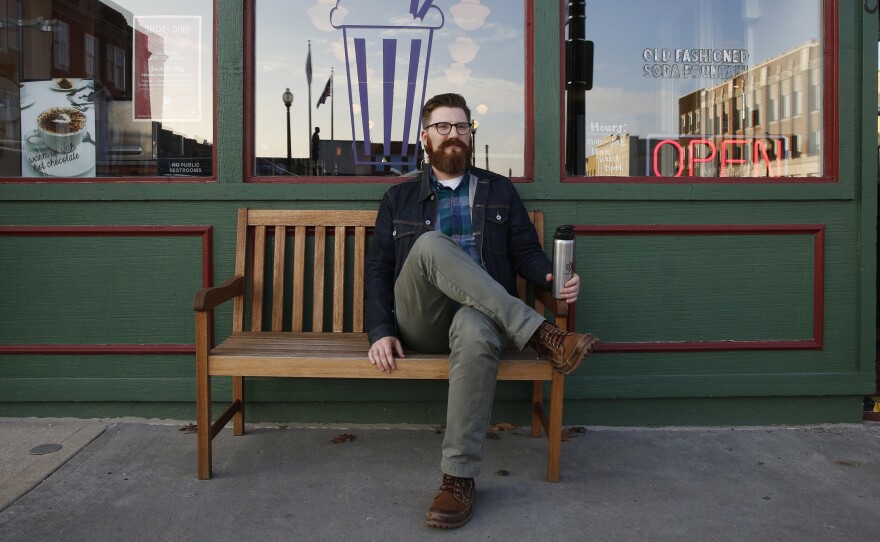 Zac Gall sits outside Clinton's Soda Fountain on Independence Square.