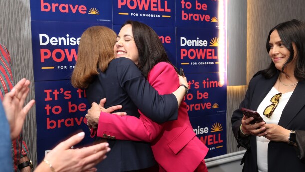 Denise Powell, candidate for the Democratic nomination to the House of Representatives in Nebraska's second district, right, hugs pollster Madeline Conway during an election night watch party Wednesday in Omaha, Neb.