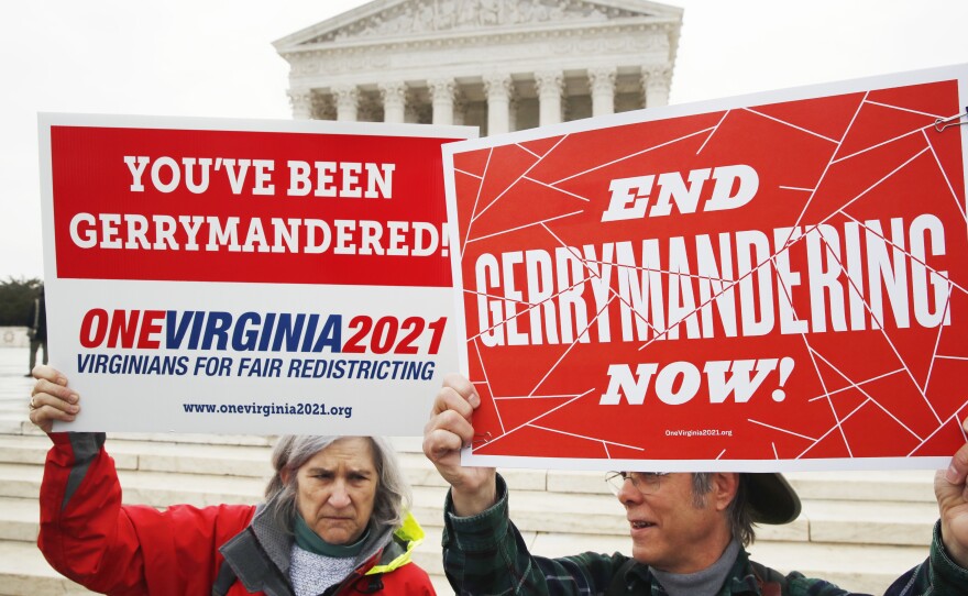 Sara Fitzgerald (left) and Michael Martin, both with the group One Virginia, protest gerrymandering in front of the Supreme Court in March.