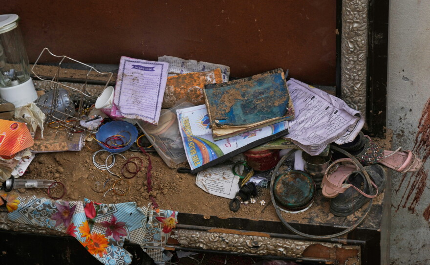Books, shoes and other stuff of victim children are seen at the site of Tuesday's roof collapse at a tutoring center roof, on the outskirts of Lahore, Pakistan, Wednesday, July 1, 2026.