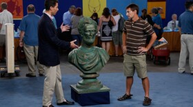 Appraiser Andrew Brunk with a guest and his Abraham Lincoln bust.
