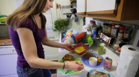 Lisa Zilligen,  a single mother and full-time student who receives food stamps, prepares lunch for her three children. Advocates for low-income Americans worry about the impact of cuts to food stamp benefits and other government programs that help the poor.